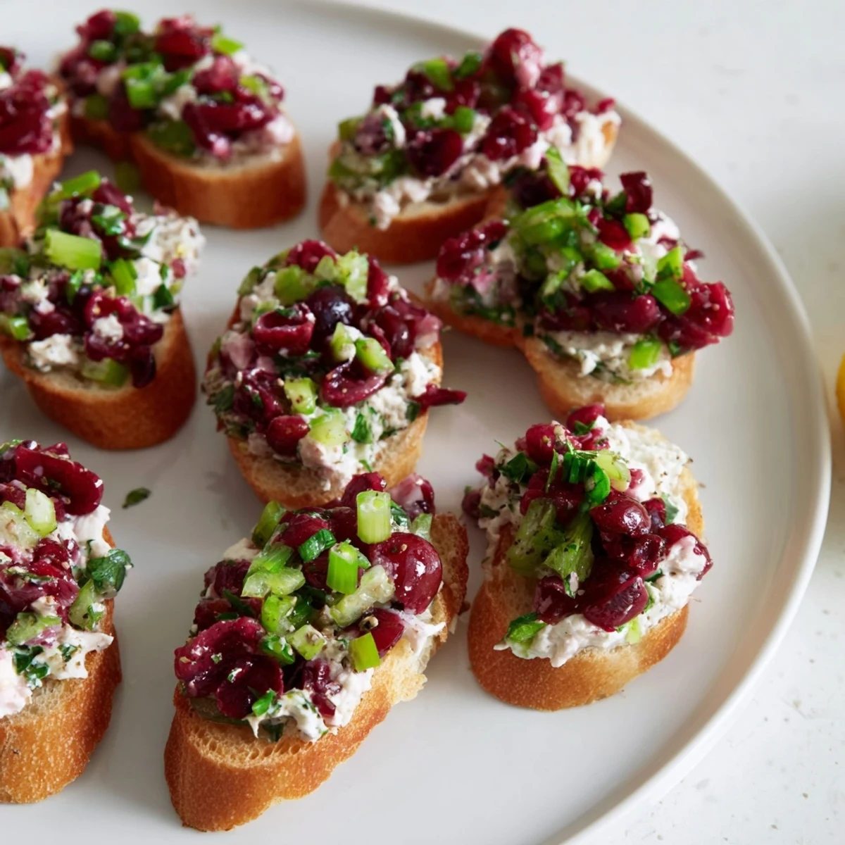 A delicious Cranberry Jalapeño Tapenade Crostini topped with vibrant colors and textures.  