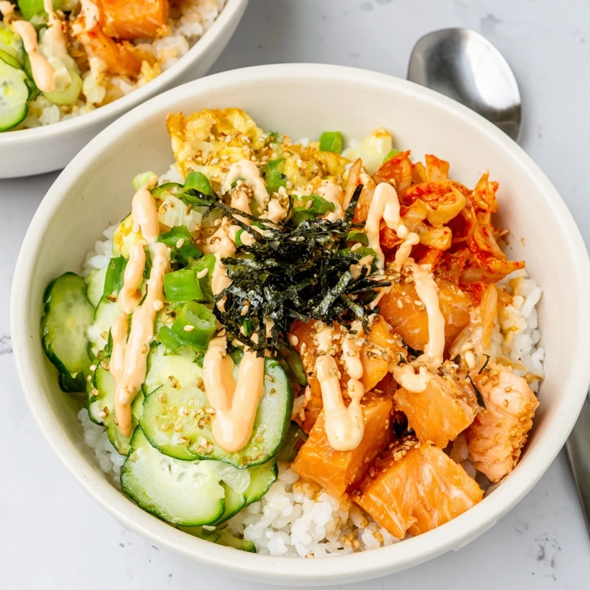 Crispy Salmon Rice Bowl topped with creamy spicy mayo and fresh avocado slices.  