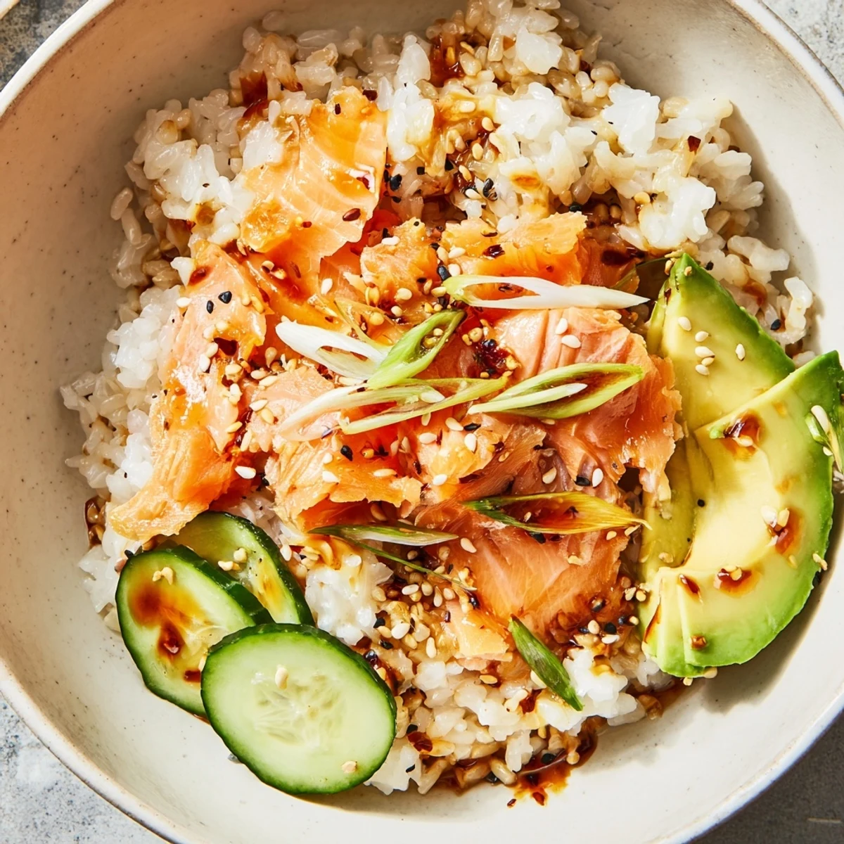 Flavor-packed Leftover Salmon & Rice Bowl, drizzled with soy sauce and sesame oil.