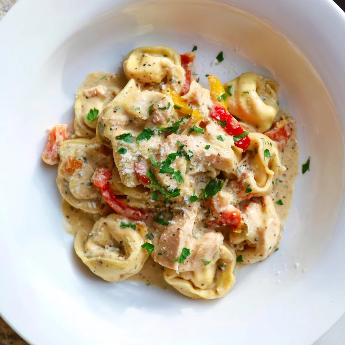 Zesty Cajun Garlic Parmesan Chicken Tortellini served with fresh parsley and Parmesan cheese  