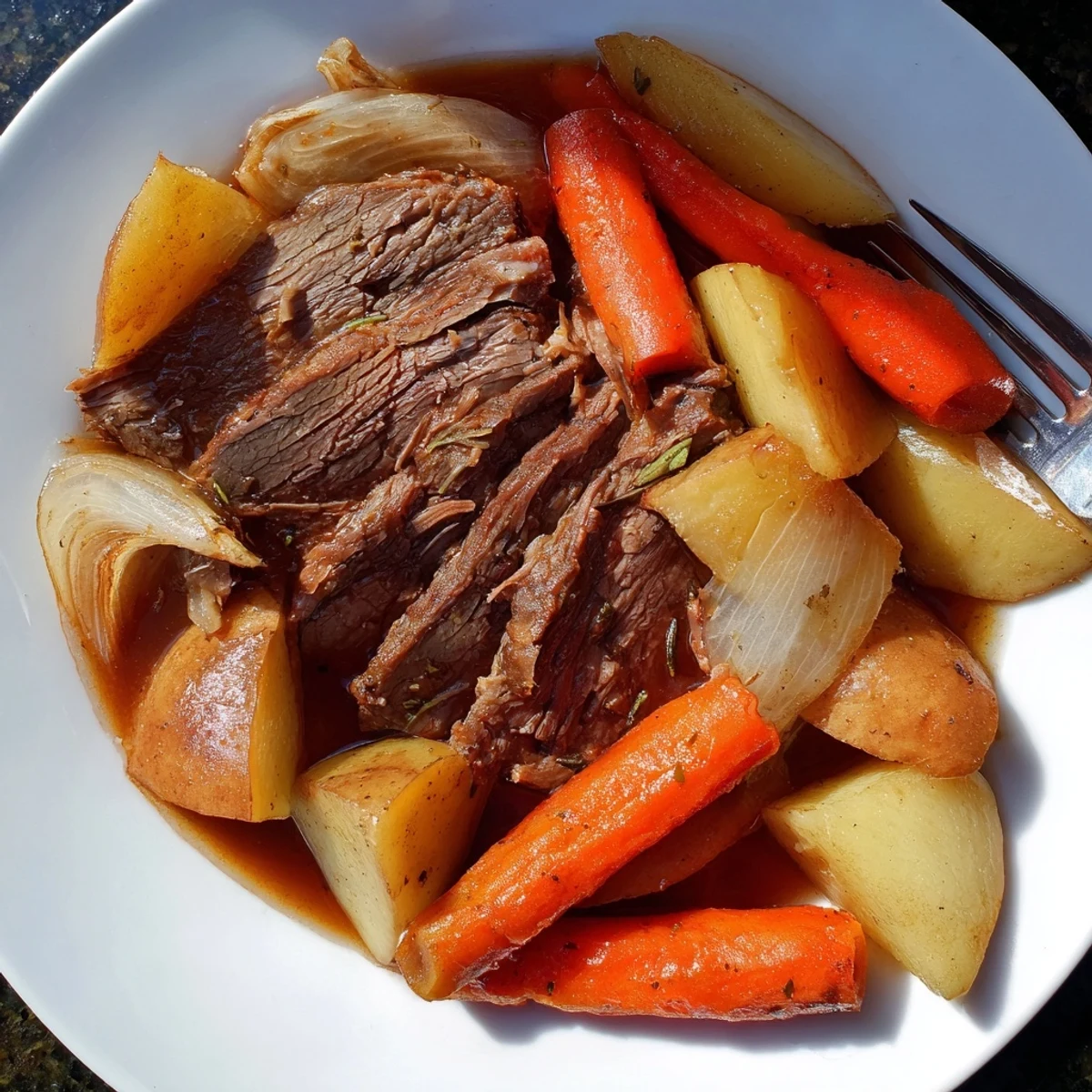 Tender Sunday pot roast with roasted veggies served in a rustic Dutch oven.  