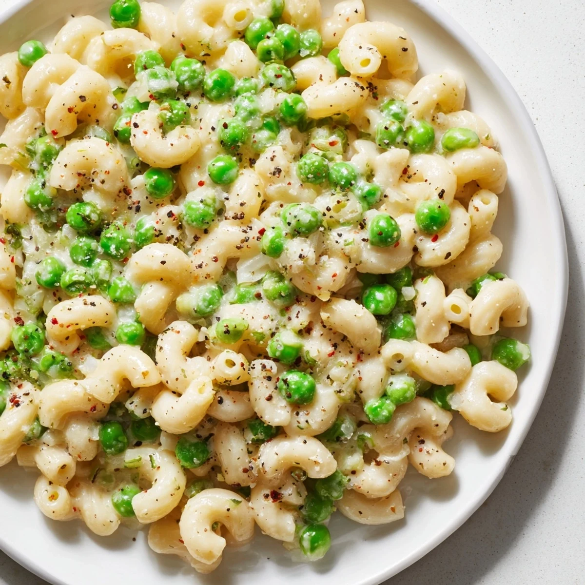 Tender macaroni with peas, simmered in a light sauce, ready to serve as Macaroni & Peas.