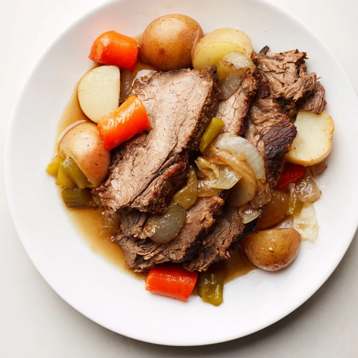 Tender Pickle Brine Pot Roast resting in its Dutch oven, surrounded by tender vegetables.
