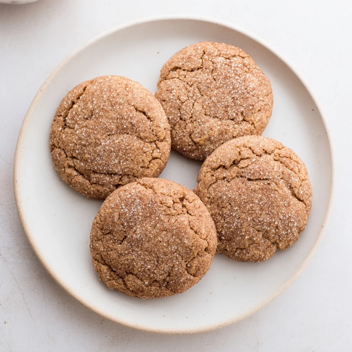 Warm, soft Chewy Soft Molasses Cookies dusted in sugar, fresh from the oven, offering a delightful treat.
