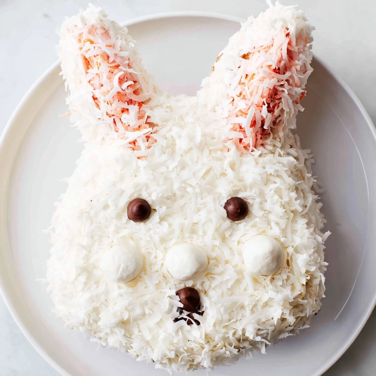 Deliciously moist Spring Bunny Carrot Cake, frosted with cream cheese, adorned to form a bunny.