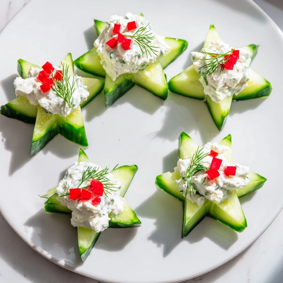 Festive Cucumber and Dill Christmas Stars appetizer, showcasing beautifully arranged star-shaped cucumber bites.