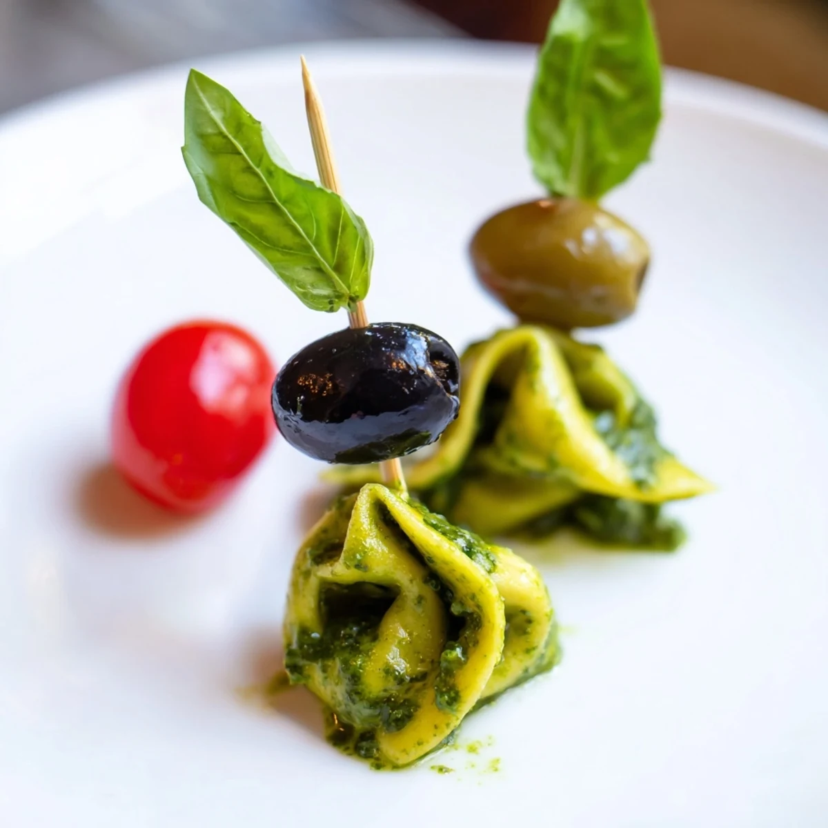 Appetizer Skewers: Tortellini, pesto, and olive skewers, a colorful Italian appetizer ready to serve with a drizzle.