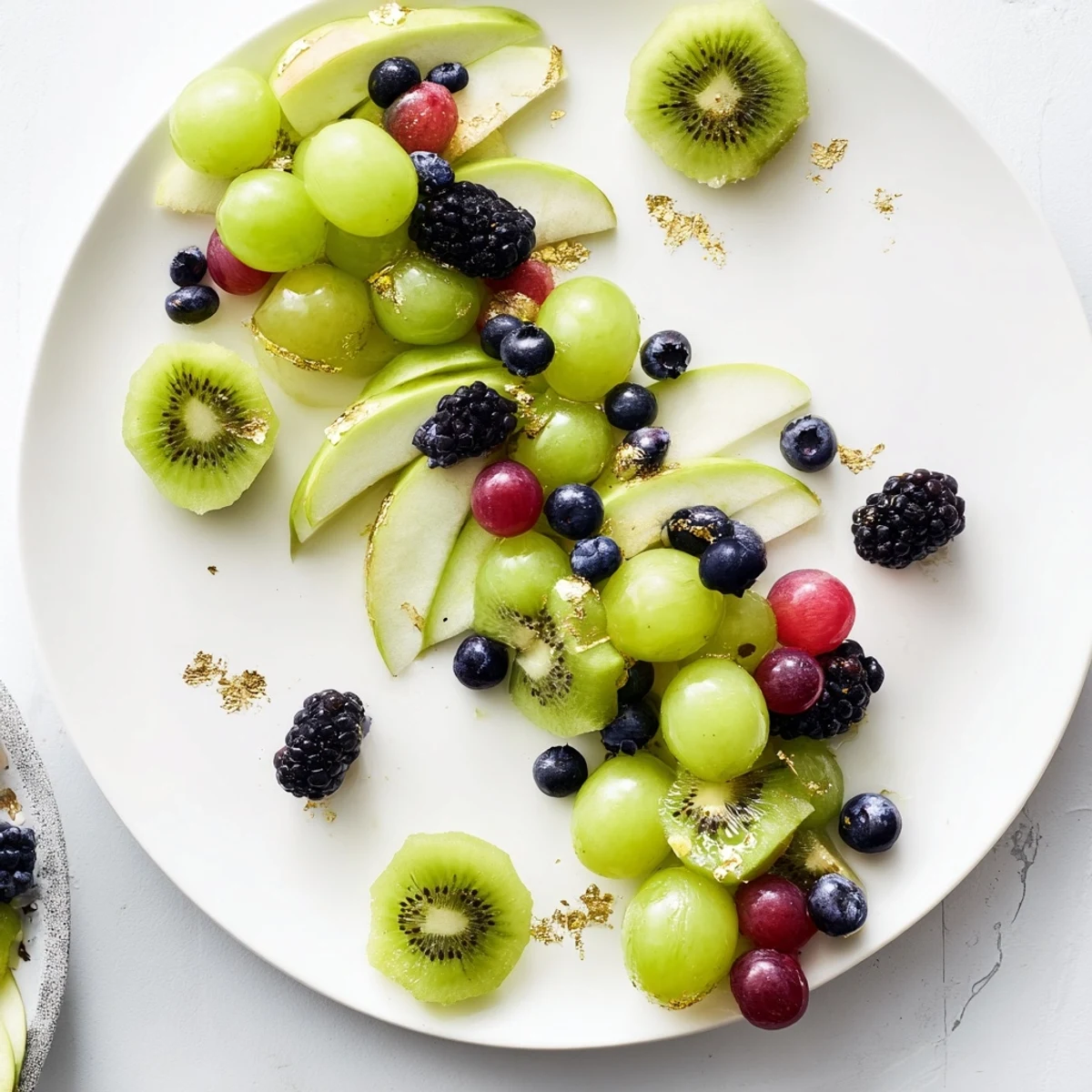 Visualize the vibrant Aurora Borealis Sweep: fresh fruit in green and purple waves, perfect for a party appetizer.