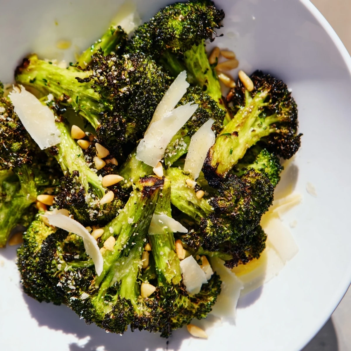 A beautiful bowl of Charred Broccoli Salad features roasted broccoli, zesty dressing, and nutty toppings.