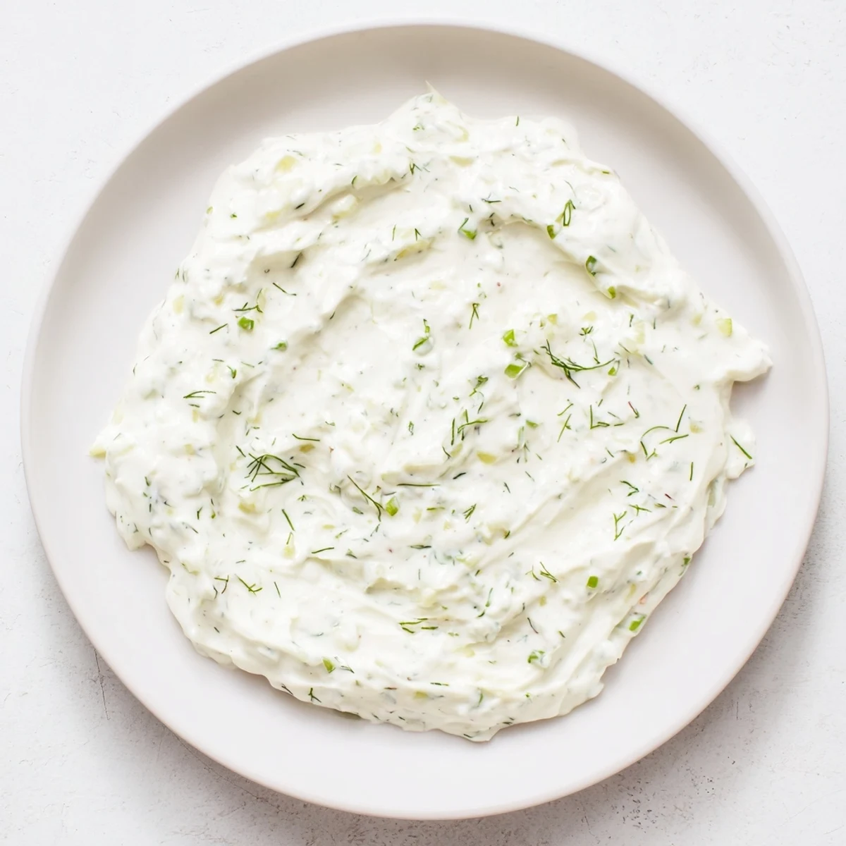 A bowl of creamy Greek Yogurt Ranch Dip, perfect for dipping fresh vegetables for a tasty snack.