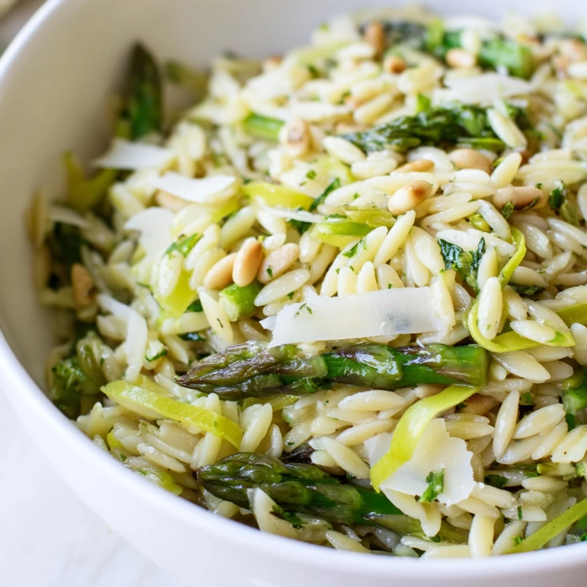 Shaved asparagus ribbons and tender orzo glisten with zesty lemon-olive oil dressing in this Asparagus Lemon Orzo Salad.