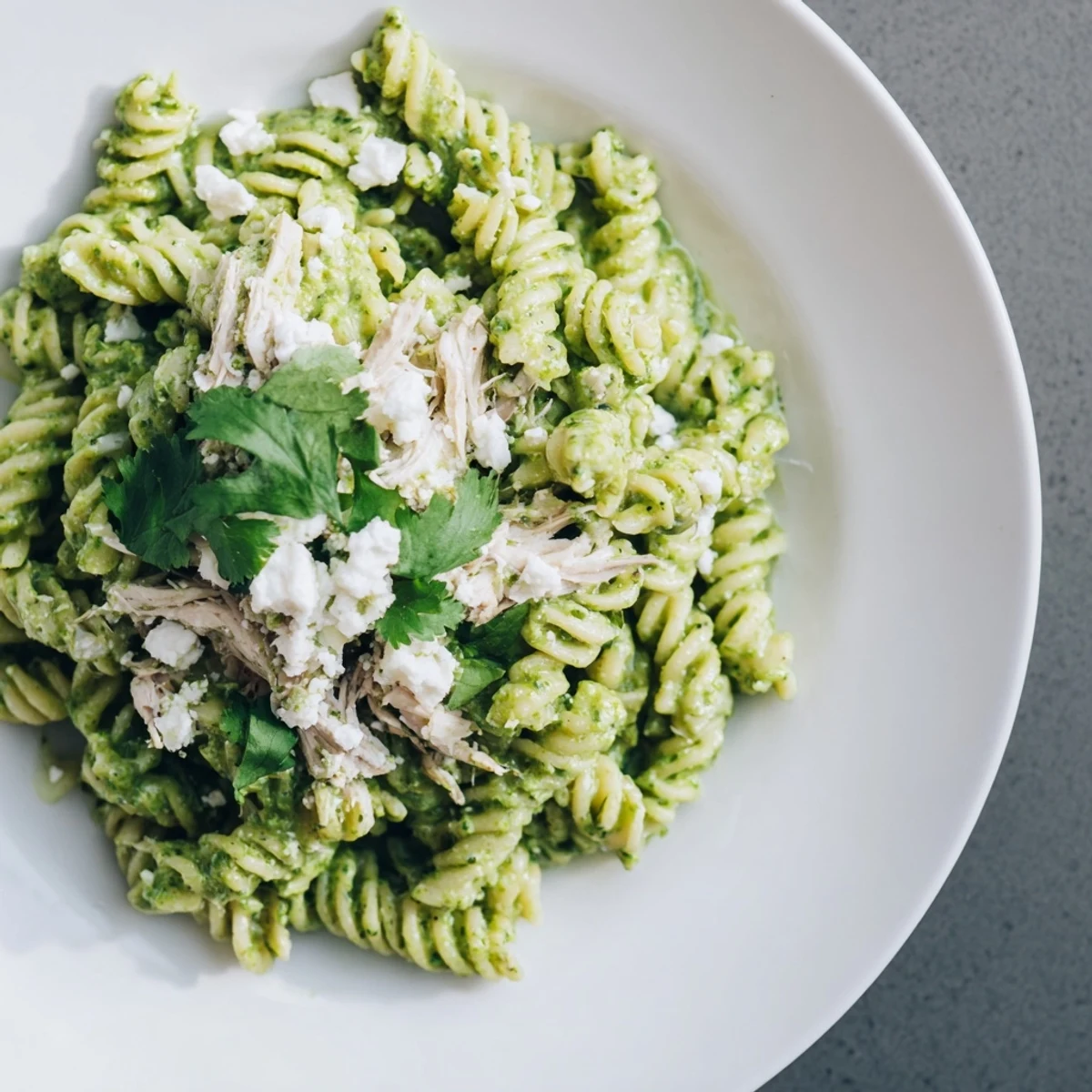 Creamy Cilantro Lime Chicken Pasta with shredded rotisserie chicken and vibrant herbs in a tangy yogurt sauce.