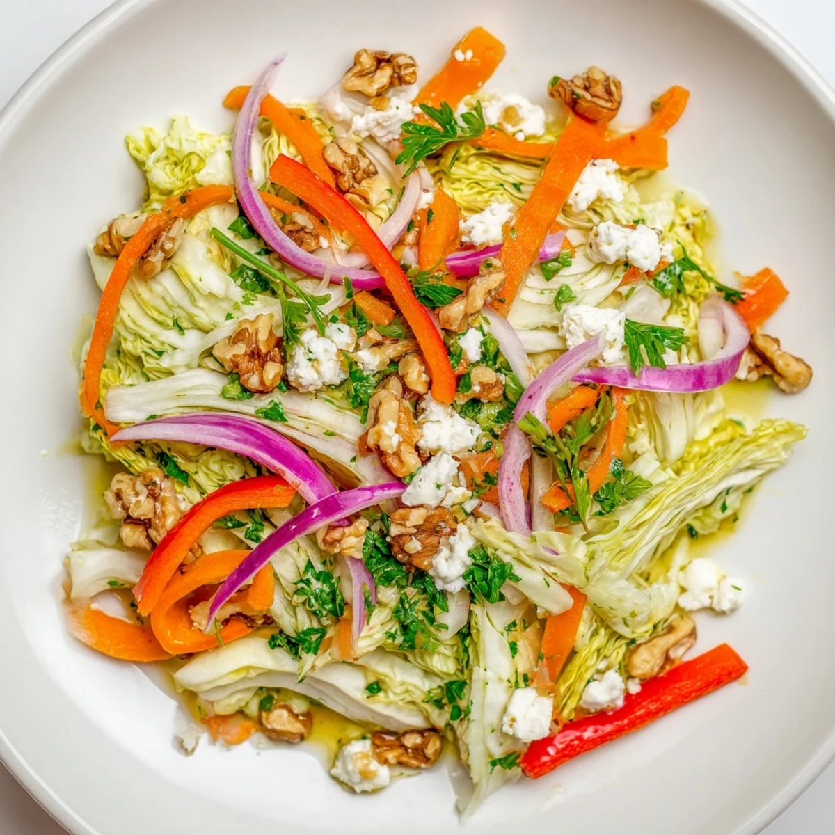 Warm sautéed Cooked and Loved Cabbage Salad with crisp carrots and bell peppers, tossed in a tangy herbaceous dressing.