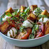 Fresh mozzarella and juicy tomatoes are layered in a bowl, drizzled with balsamic and olive oil in this vibrant Caprese Salad Bowl.