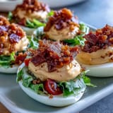 Classic deviled eggs get a BLT twist with smoky bacon, diced tomatoes, and crisp romaine for a party-perfect appetizer.