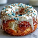 Tower of glazed donuts, glistening with colorful sprinkles, ready for your grad's party.