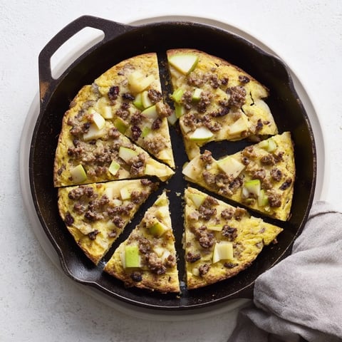 Golden Savory Apple, Sausage, and Cheddar Scone Skillet, served warm and rustic, loaded with delicious flavors.