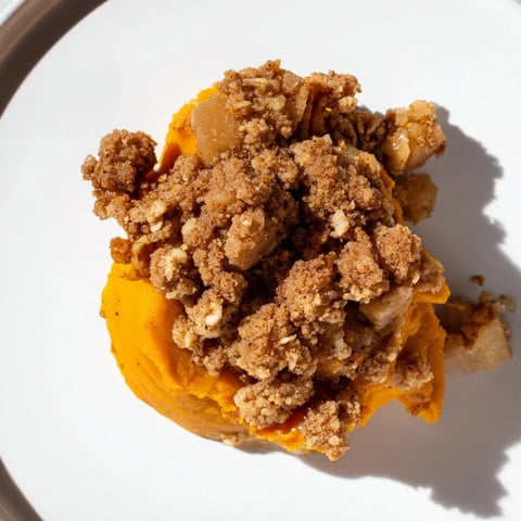 Golden-brown pumpkin crisp, warm from the oven, with a buttery, sweet crumble topping.