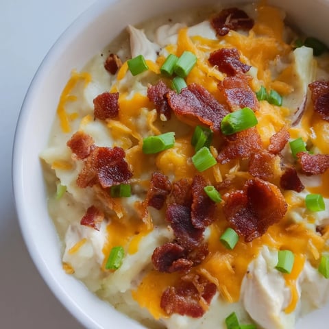 Crockpot Loaded Baked Potato Soup: a steaming bowl featuring bacon and melty cheese, ready to enjoy.