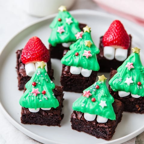Fudgy Express Christmas Tree Brownie Hats, bursting with sprinkles and green chocolate, ready for holiday treats.
