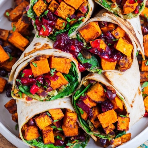 Golden roasted sweet potato and black bean holiday wraps, bursting with vibrant vegetables and spices.
