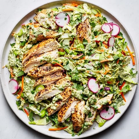 Delectable Green Goddess Cabbage Slaw with beautifully grilled chicken, ready to enjoy for dinner.