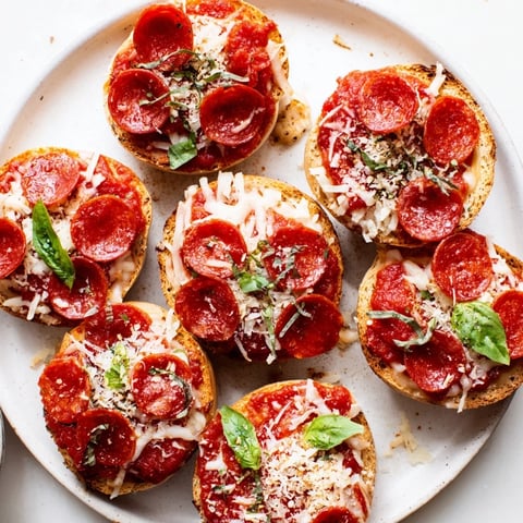 Mini Pepperoni Pizza Bagel halves with melted cheese and crispy pepperoni, ideal for a quick snack.