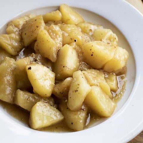 Slow cooker stewed apples bubbling gently, a warm cinnamon scent fills the kitchen.