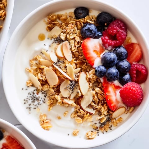 Creamy Greek yogurt bowl topped with fresh berries, crunchy granola, a perfect dry yogurt breakfast.
