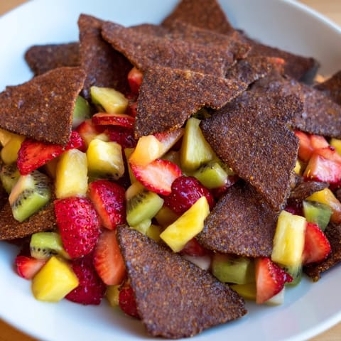 Homemade chocolate tortilla chips paired with fresh fruit salsa for a delightful treat.  