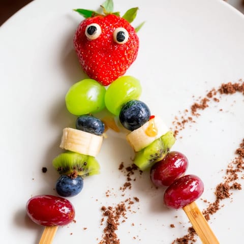 Sweet Caterpillar Fruit Skewer Track, featuring juicy grapes and strawberries winding along a chocolate cookie track.