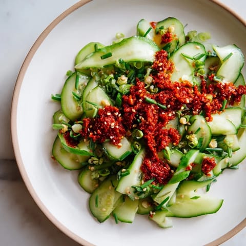 A delightful view: Cucumber shaker salad, glistening with zesty dressing and crunchy chili crisp.