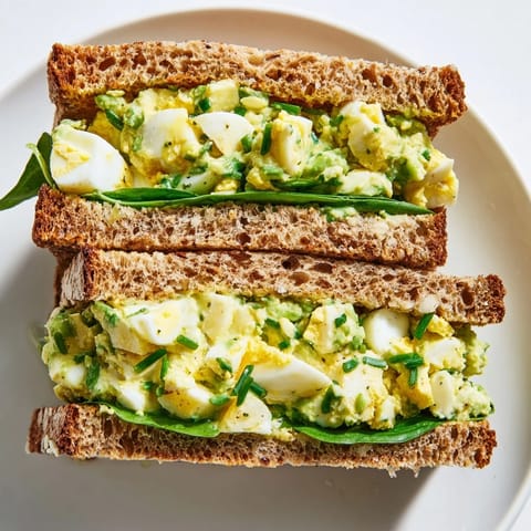 Bright lemon and chives flavor the lightened egg salad filling in this satisfying avocado egg salad sandwich.