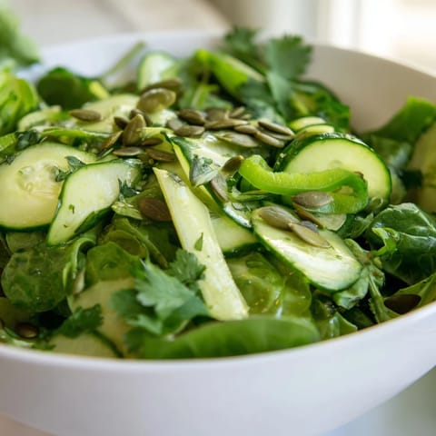 A close-up of the Glowing Green Salad highlights crunchy celery, fresh parsley, and glistening olive oil dressing.  