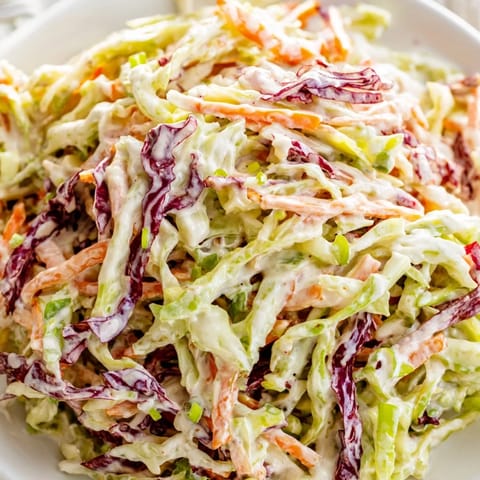 Golden pulled pork sandwiches topped with tangy Best Cabbage Coleslaw, offering a cool, crunchy contrast to rich BBQ flavors.