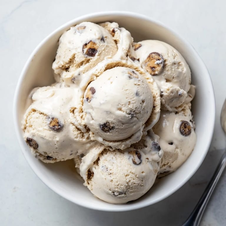 A bowl of cottage cheese ice cream topped with edible cookie dough and chocolate chips.  