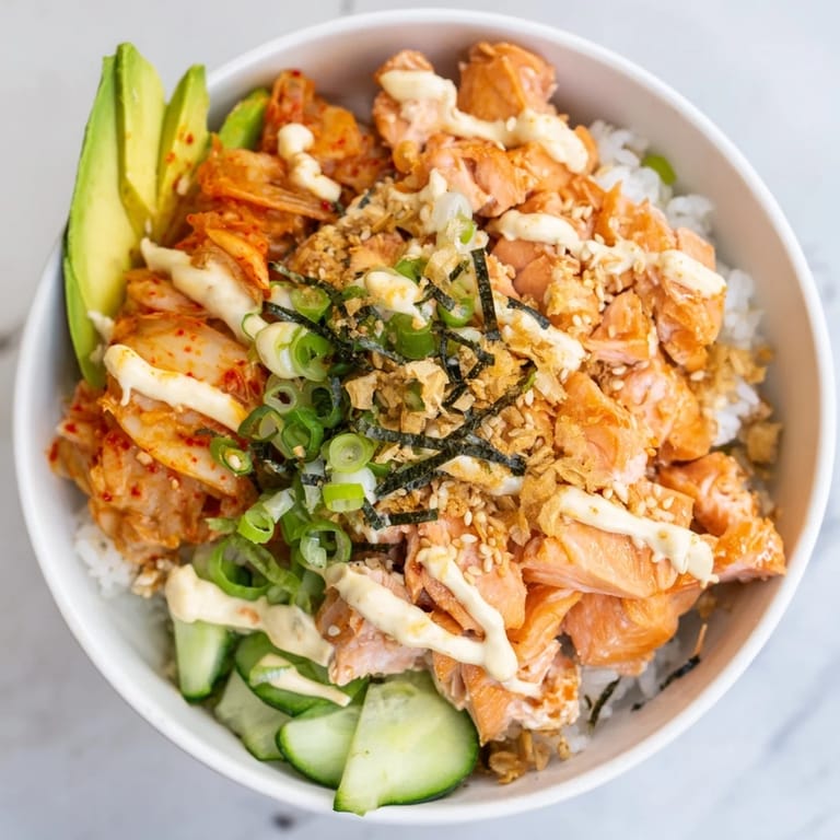Delicious, vibrant Crispy Salmon Rice Bowl garnished with sesame seeds and scallions.