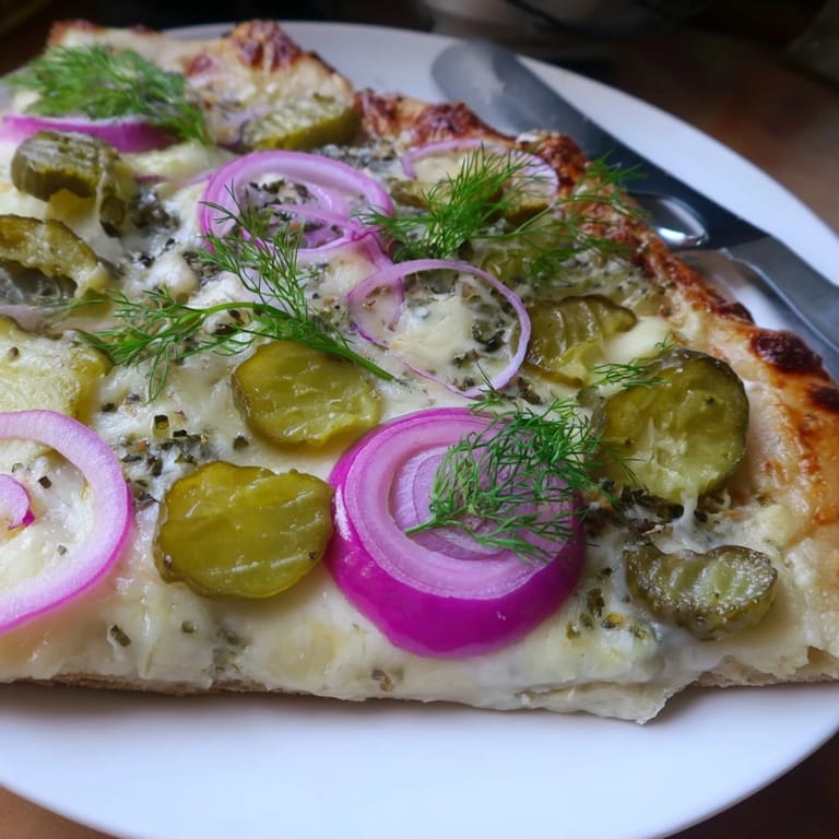 Enjoy a slice of tangy Pickle Pizza with a rich crème fraîche sauce.  